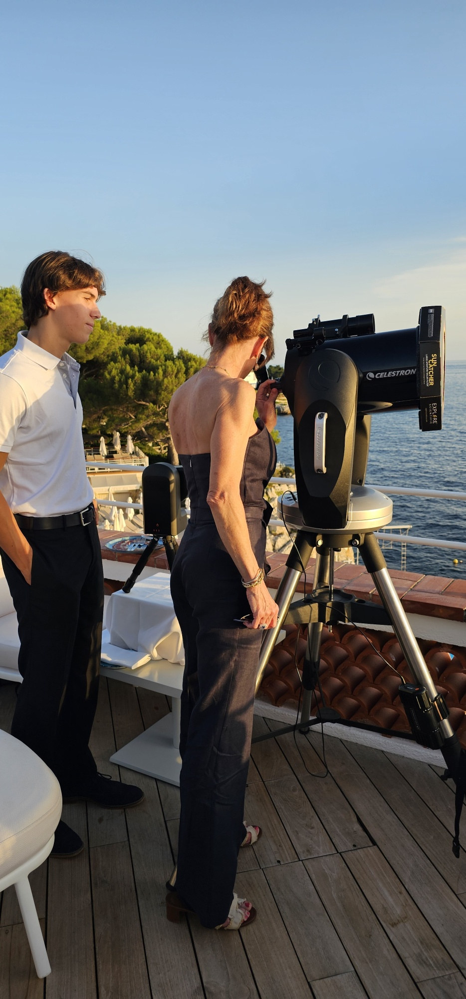 Guest observing through a telescope